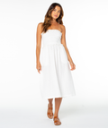 A woman wears the Roxy Avalon Tube Midi Dress, a strapless style with a smocked bodice and flowy skirt, paired with brown sandals against a plain white background.