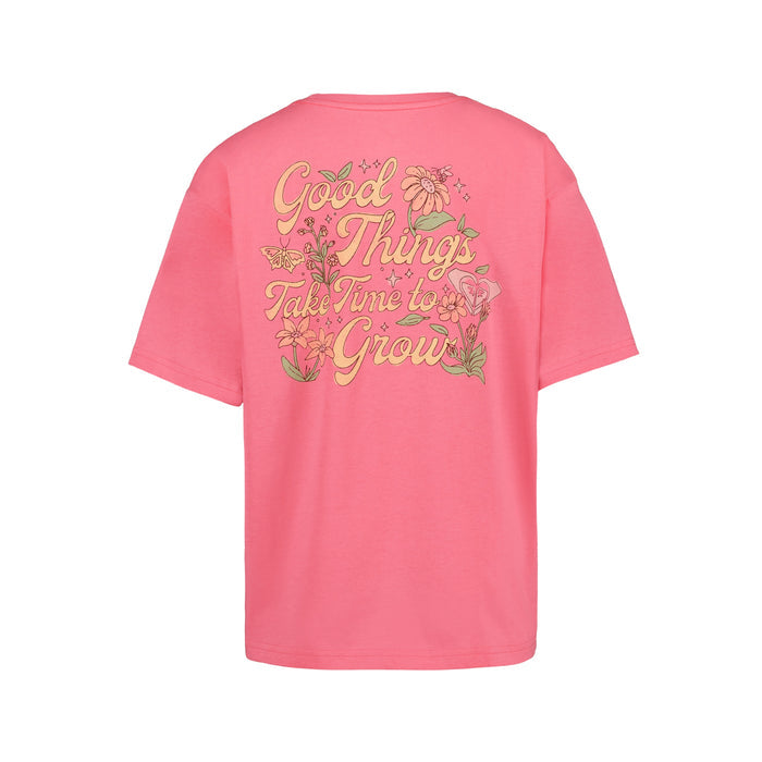 The Girls' Good Things Oversized Tee by Roxy is a pink cotton boyfriend tee with “Good Things Take Time to Grow” in bold yellow script and floral graphics on the back.