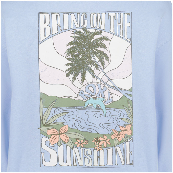 A scenic beach graphic with palm trees, a sunrise, flowers, water, and mountains decorates the Girls’ Ocean Explorer Crew from Roxy. The words “BRING ON THE SUNSHINE” appear above the scene, while “Roxy” with a wave is featured in the water. Soft pastel tones bring color to this crewneck pullover sweater.