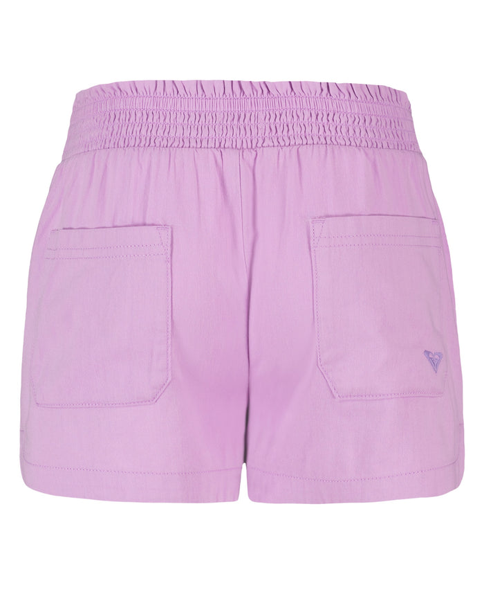 The Roxy Girls' Soleil Short features light purple brushed twill, a smocked elastic waistband, two roomy back pockets with a stitched logo on the right, and a casual, relaxed fit—perfect for laid-back days.