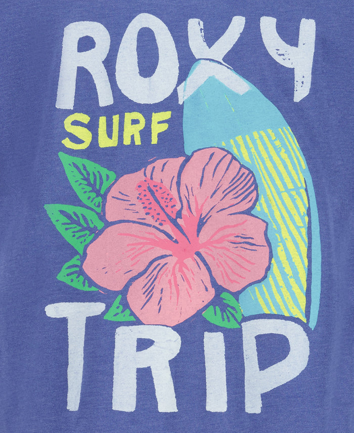 The Roxy Girls' Surf Trip Tee features "ROXY SURF TRIP," a pink hibiscus with green leaves, and a blue and yellow surfboard on a blue background, all on soft cotton jersey.