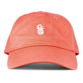 The Roxy Next Level Cap is a women’s baseball hat in papaya, crafted from soft cotton twill, featuring a small white embroidered pineapple on the front and a classic curved visor, shown against a white background.