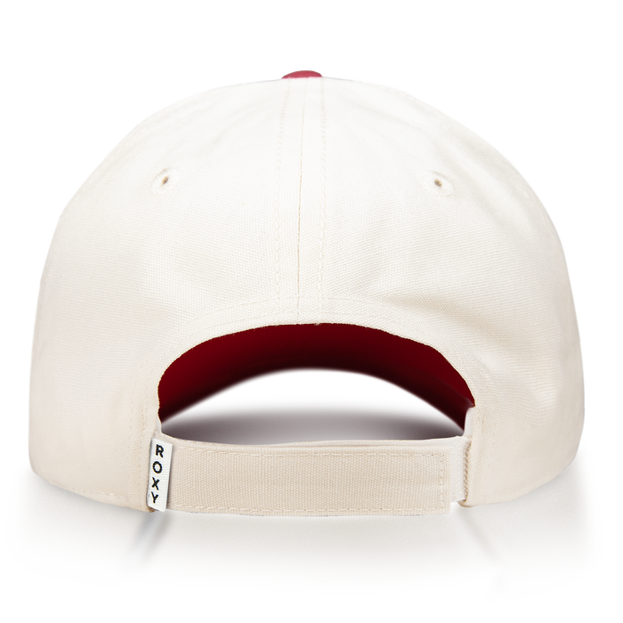 The Roxy Next Level Cap is a cream-colored women’s baseball hat made from soft cotton twill, shown from the back to highlight its adjustable strap with a small white ROXY tag. The inside features a red fabric lining, while the curved visor offers a classic finish.