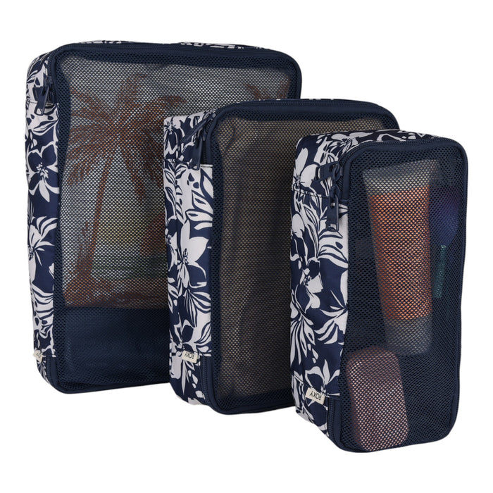 The Roxy Packing Cube Set includes three navy blue mesh travel pouches with white floral patterns, each holding personal care essentials such as bottles and a toothbrush. Designed from lightweight ripstop material, these packing cubes are ideal for keeping your travel items organized.