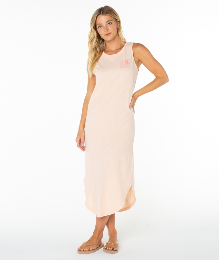 A woman with long blonde hair wears the Roxy Peace Waves Wildflower Midi Dress and tan flip-flops, standing against a plain white background with one hand at her side and the other on her hip.