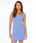 A woman with long brown hair wears a light blue, short-sleeved Roxy Sirena Mini Dress with a square neckline, standing facing forward against a plain white background.