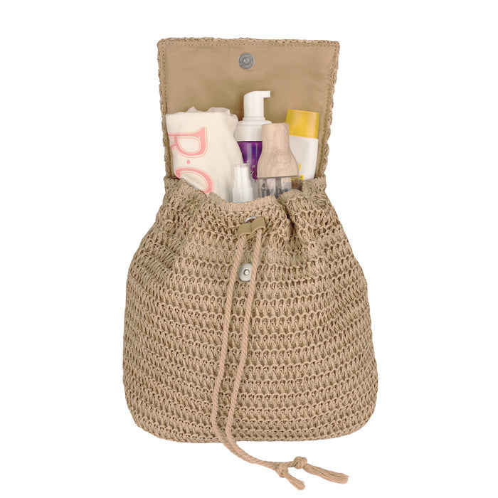 The Roxy Spotless Sunnies Backpack is a large beige woven bag with a flap closure and adjustable cotton straps, shown open to display organized toiletries and bottles—such as lotion, spray, and tubes—inside.