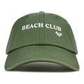 Oil green Toadstool Cap by Roxy, featuring the words BEACH CLUB embroidered in white above a small white heart on the front, displayed against a plain white background. Perfect for fans of cool style, this cap embodies the laid-back vibe of classic Roxy baseball hats.